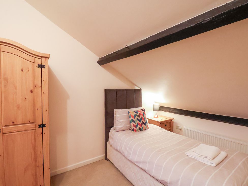A bedroom with a bed and wardrobe at The Lodge Snainton near Scarborough