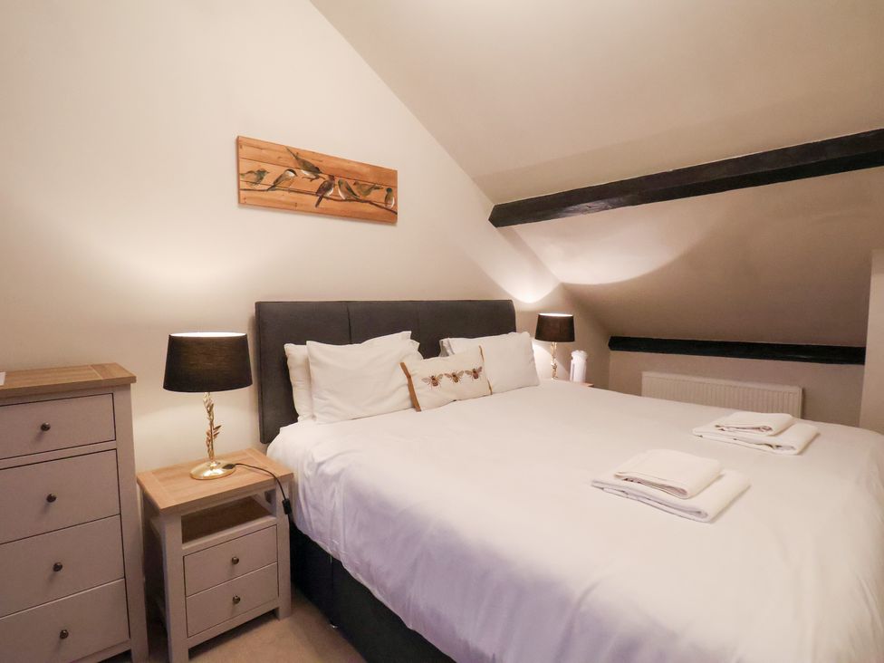 A bedroom with a bed and bedside table at The Lodge in Snainton near Scarborough