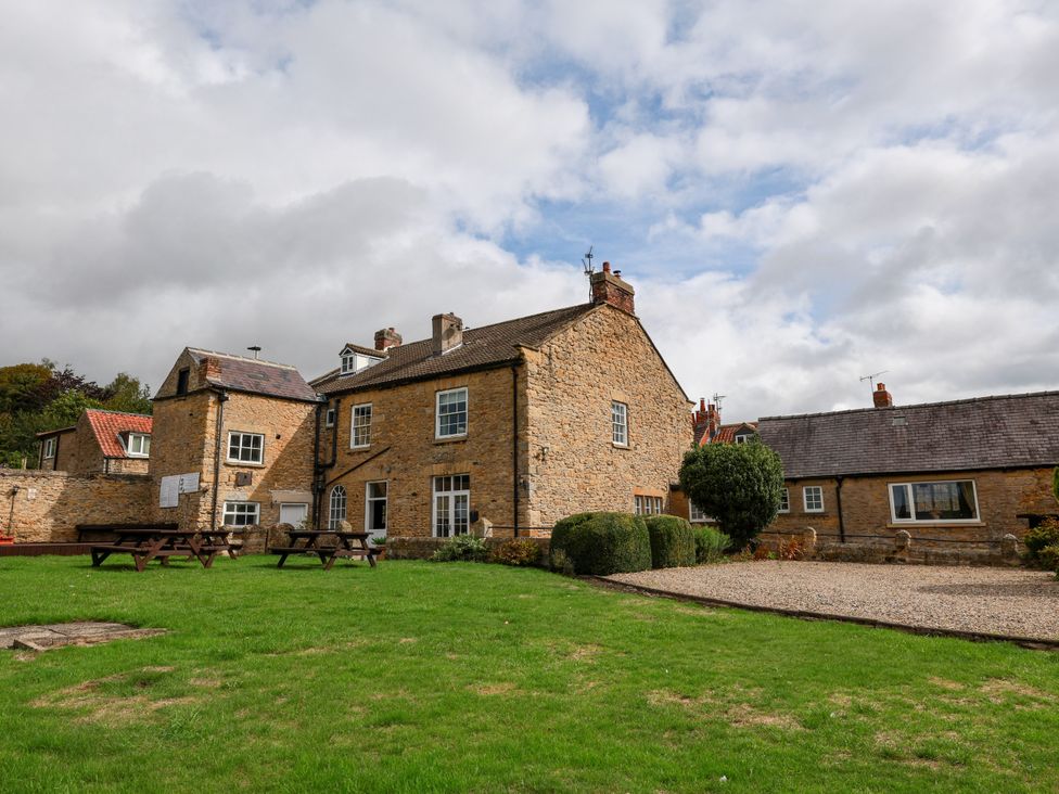 A house with outdoor space and benches at The Lodge in Snainton near Scarborough
