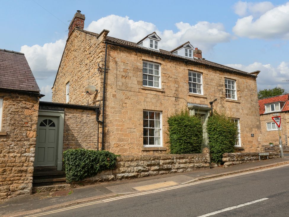 A house with a green door and windows at The Lodge Snainton near Scarborough