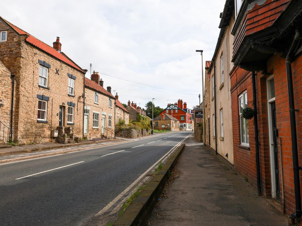 A street scene with houses and a road at The Lodge Snainton near Scarborough