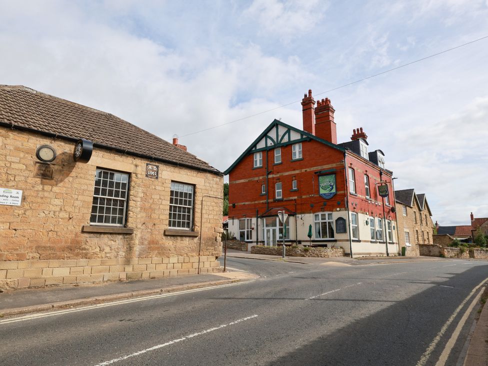 A street scene with buildings and road at The Lodge in Snainton near Scarborough