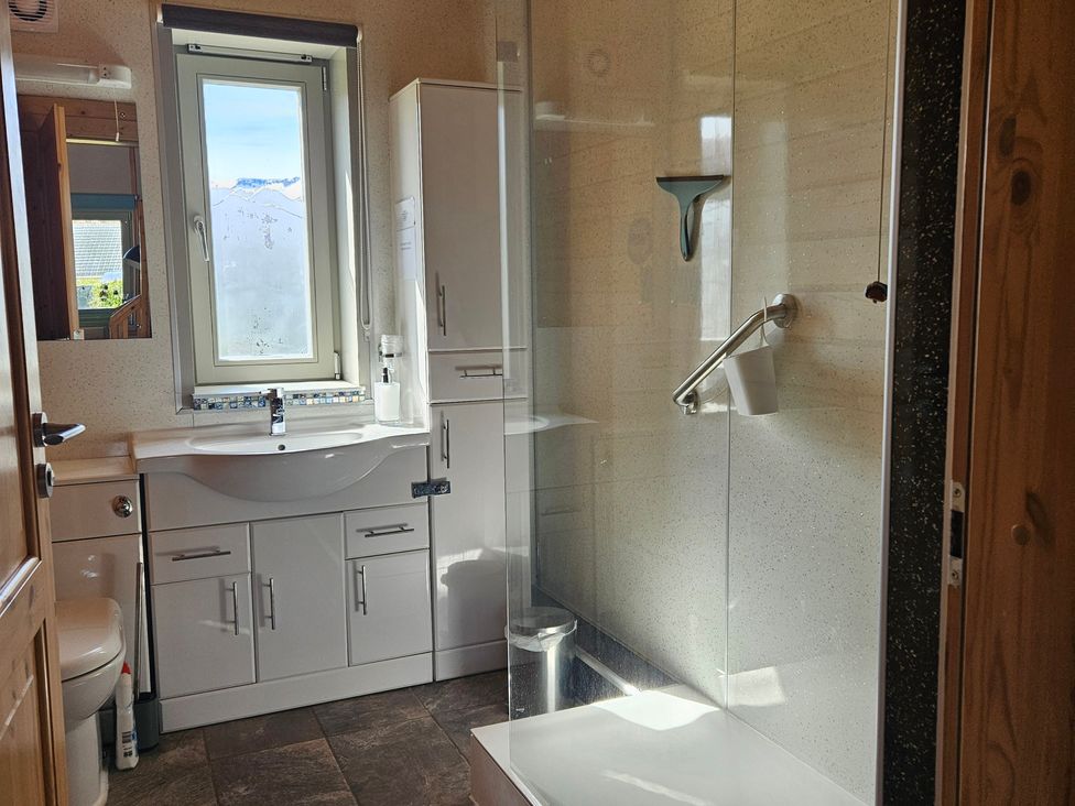 A bathroom with a shower and sink at Orion Lodge Roy Bridge near Fort William
