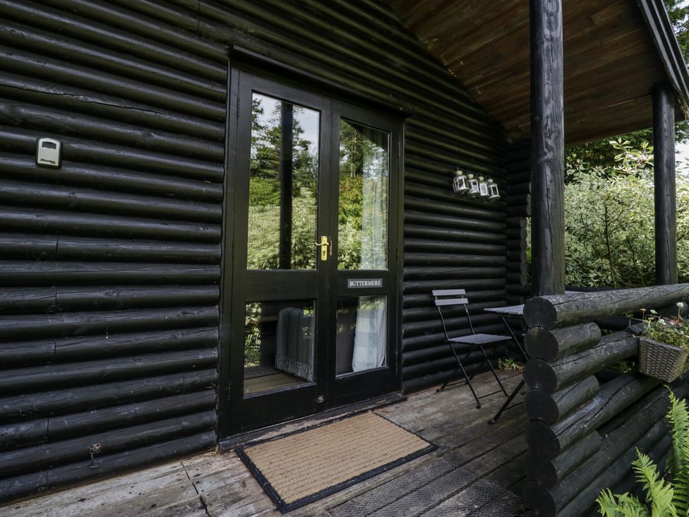 An entrance with a door and seating at Buttermere in Spark Bridge near Greenodd