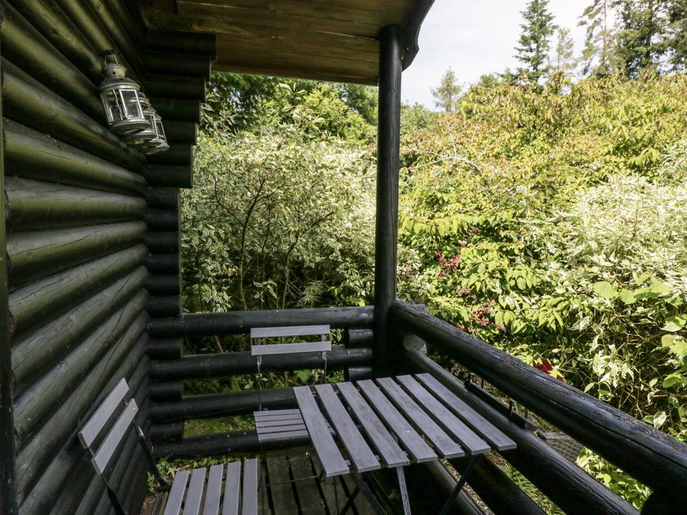 A balcony with a table and chairs at Buttermere Spark Bridge near Greenodd