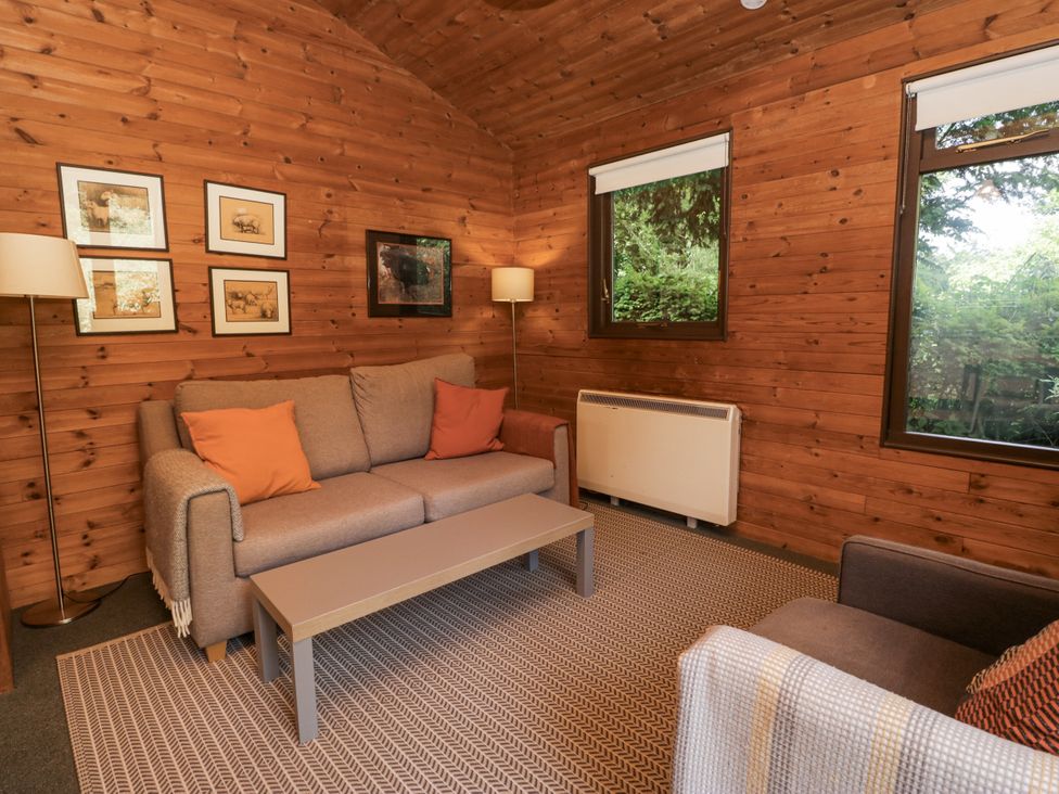 A living room with a sofa and armchair at Buttermere Spark Bridge near Greenodd