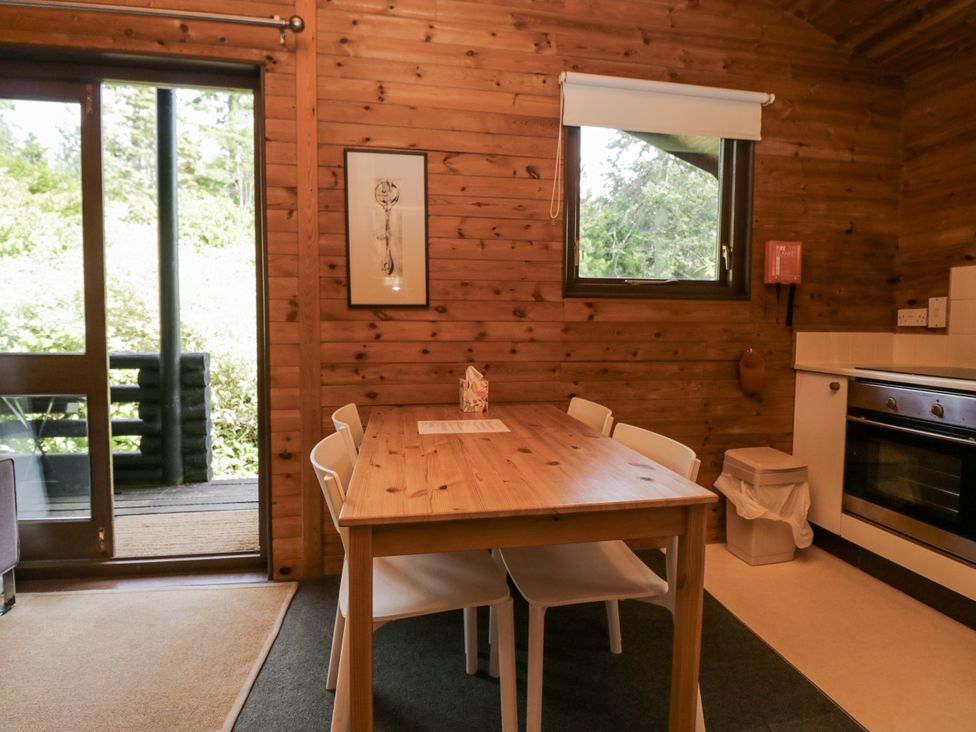 A dining room with a table and chairs at Buttermere Spark Bridge near Greenodd