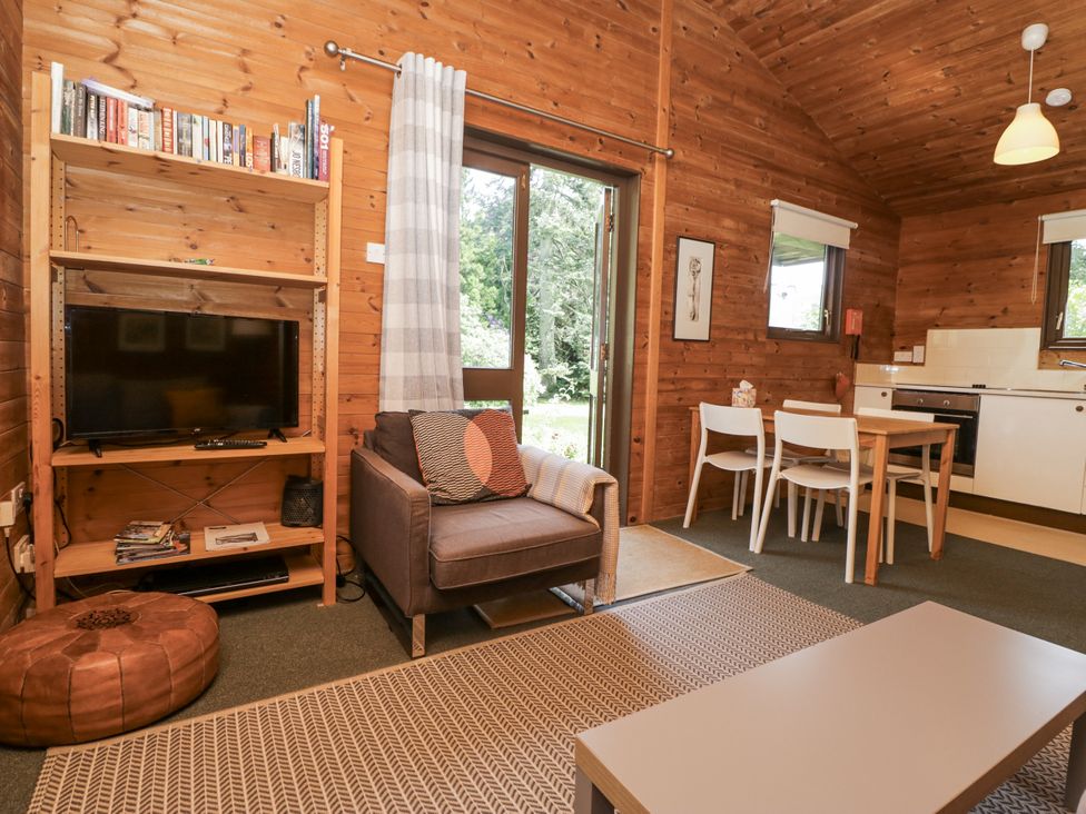 A living room with a sofa and dining area at Buttermere, Spark Bridge near Greenodd