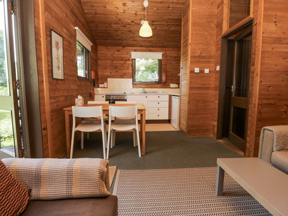 A kitchen area with a table and chairs at Buttermere, Spark Bridge near Greenodd