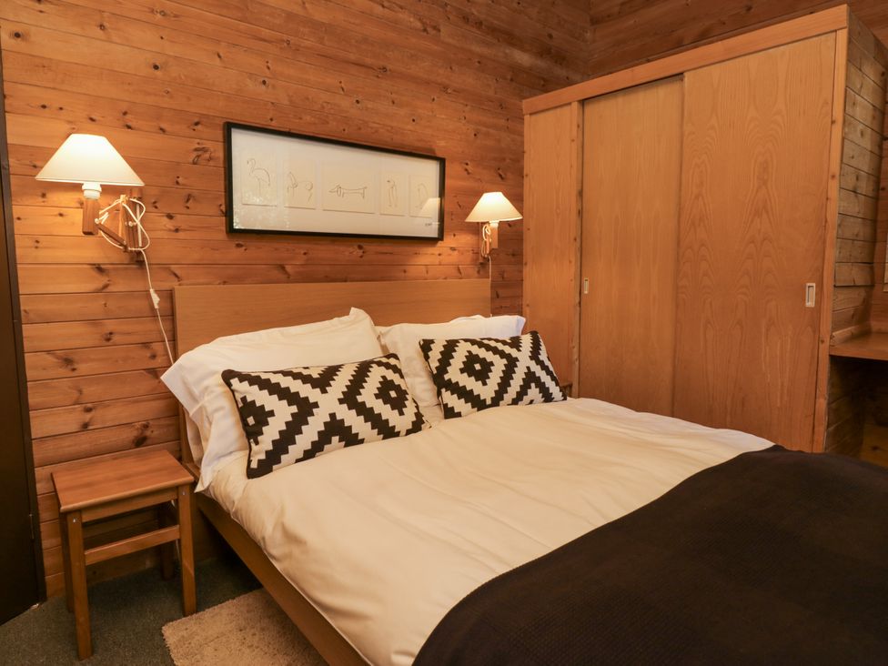 A bedroom with a bed and bedside table at Buttermere Spark Bridge near Greenodd