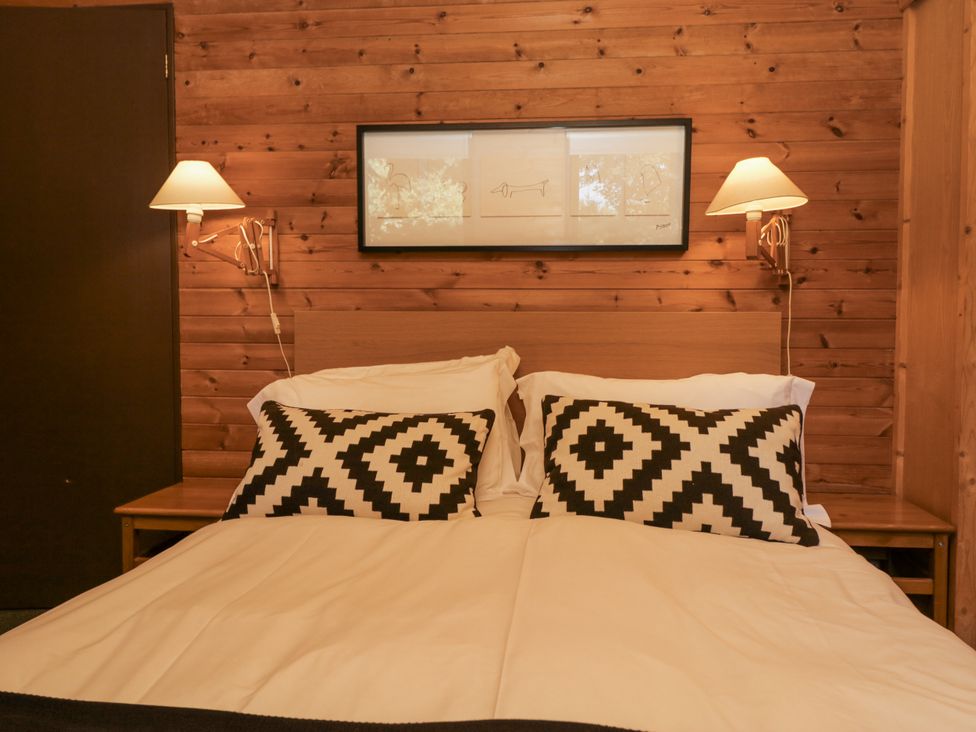 A bedroom with a bed and bedside lamps at Buttermere in Spark Bridge near Greenodd