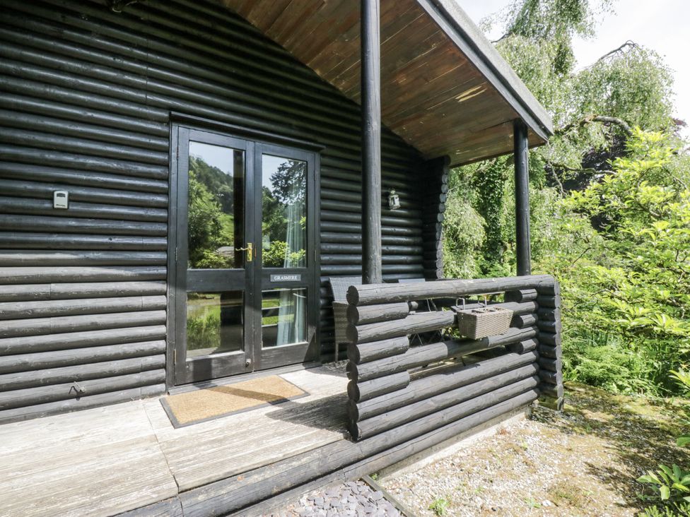 A front porch of a log cabin at Grasmere Spark Bridge near Greenodd
