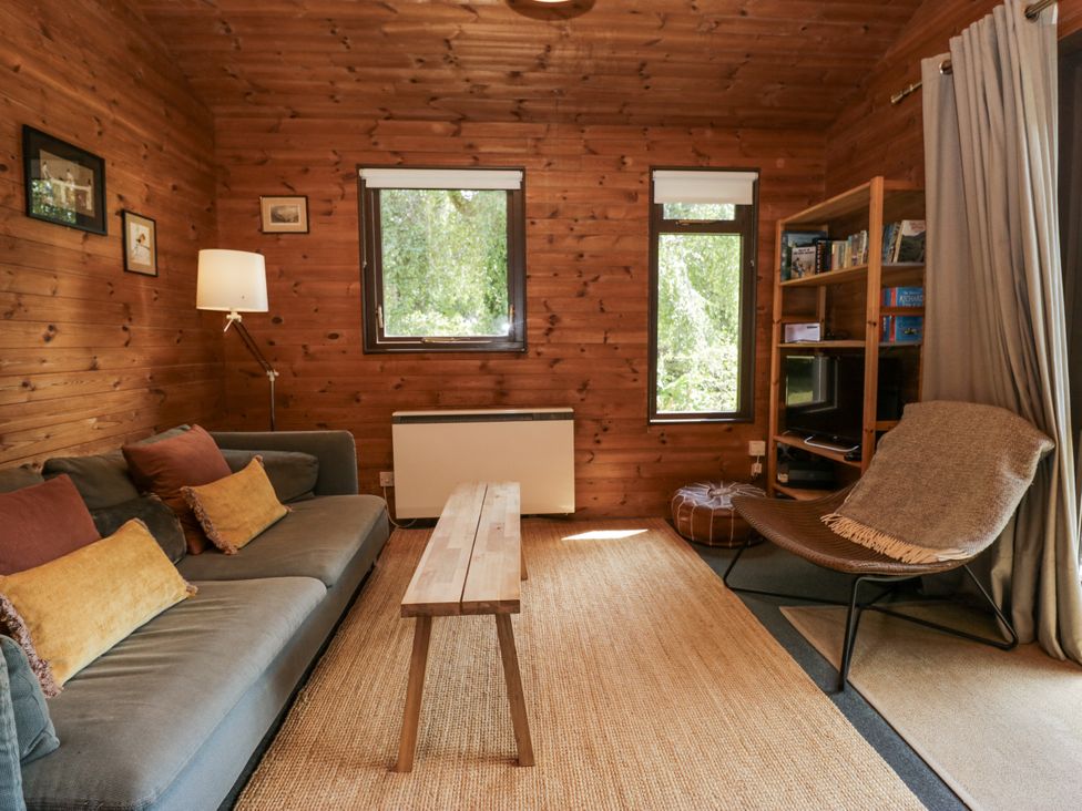 A living room with a sofa and coffee table at Grasmere in Spark Bridge near Greenodd