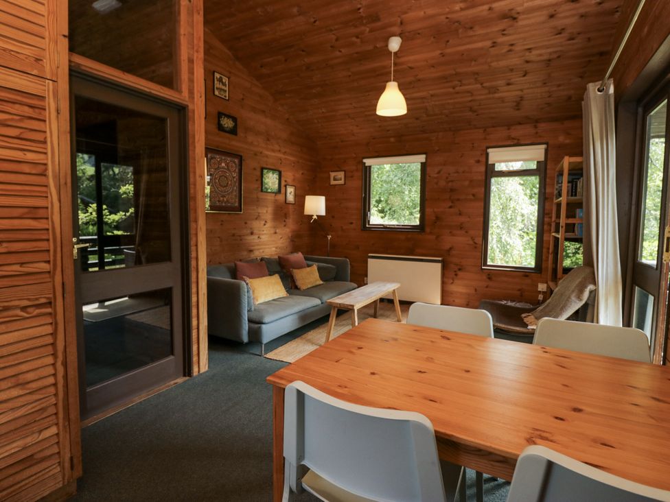A living room with a sofa and a table at Grasmere in Spark Bridge near Greenodd