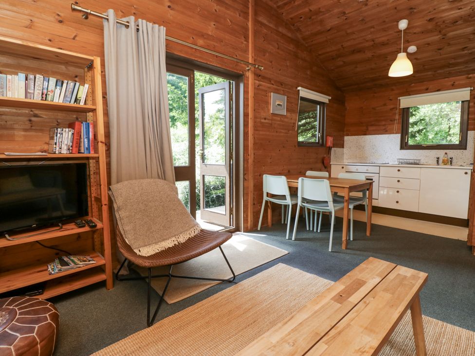 A living room with a television and seating at Grasmere in Spark Bridge near Greenodd