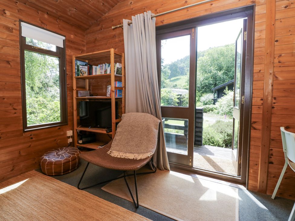 A snug with a chair and TV at Grasmere Spark Bridge near Greenodd