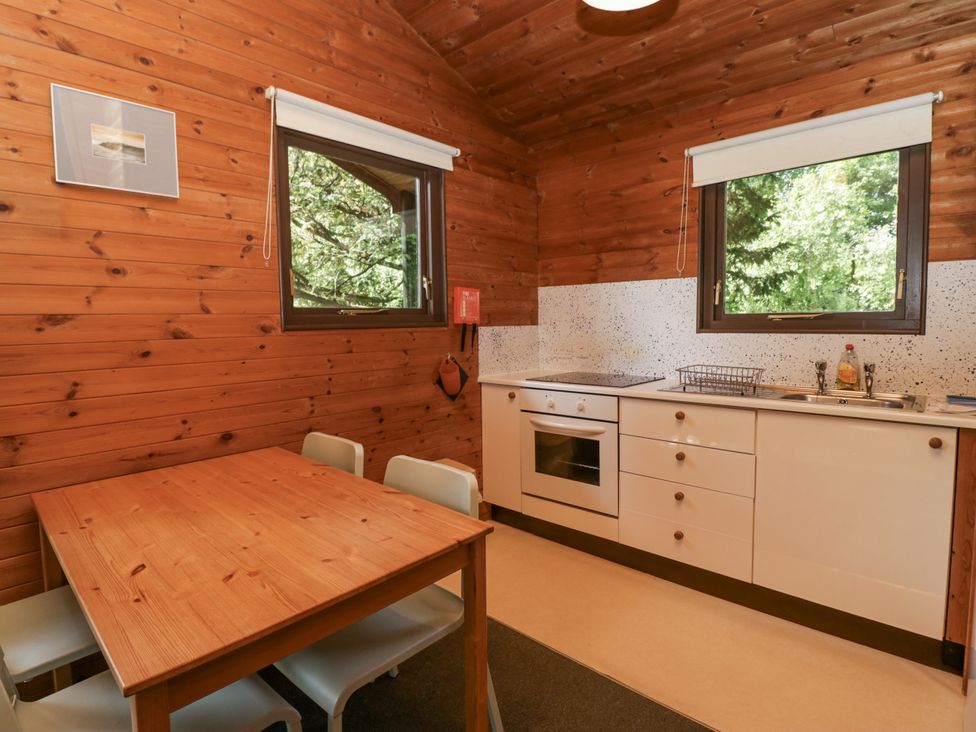 A kitchen with a table and chairs at Grasmere in Spark Bridge near Greenodd
