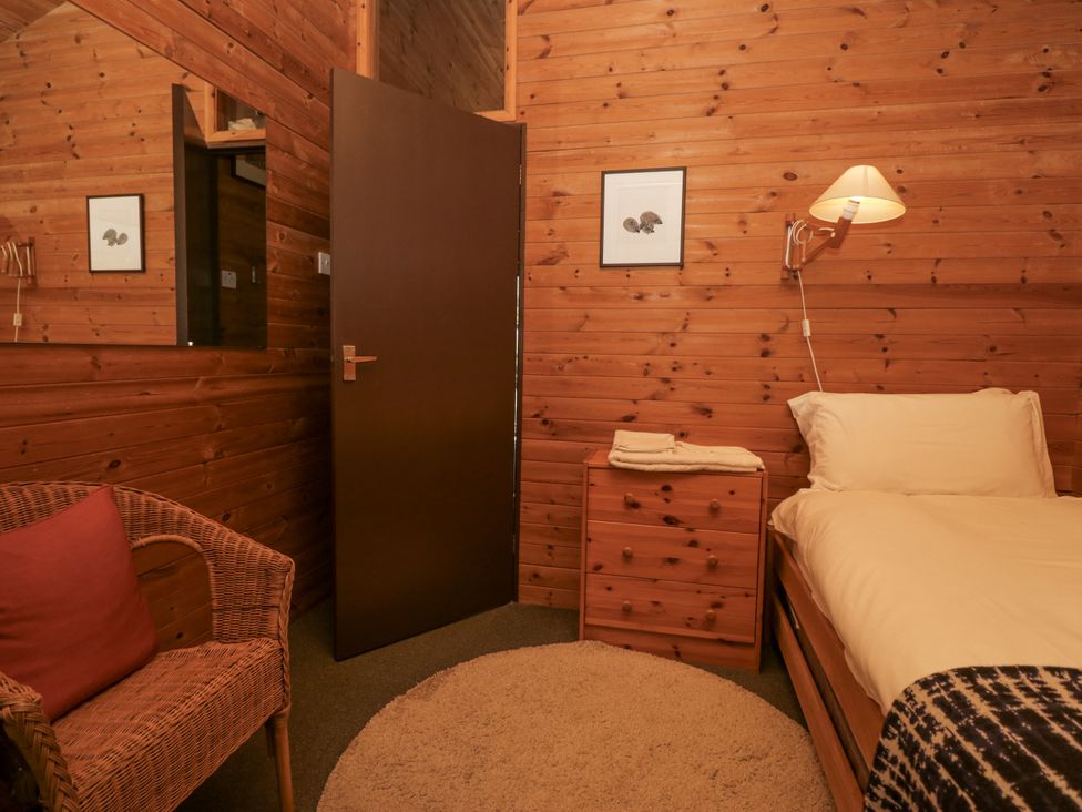 A bedroom with a bed and nightstand at Grasmere in Spark Bridge near Greenodd
