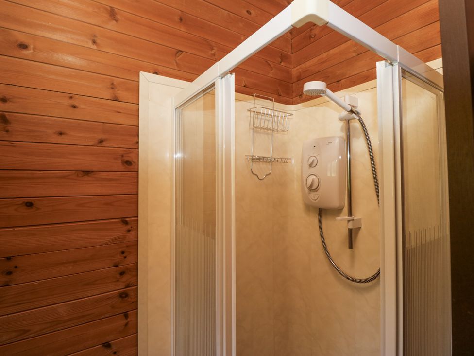 A shower with a white showerhead and controls at Grasmere in Spark Bridge near Greenodd