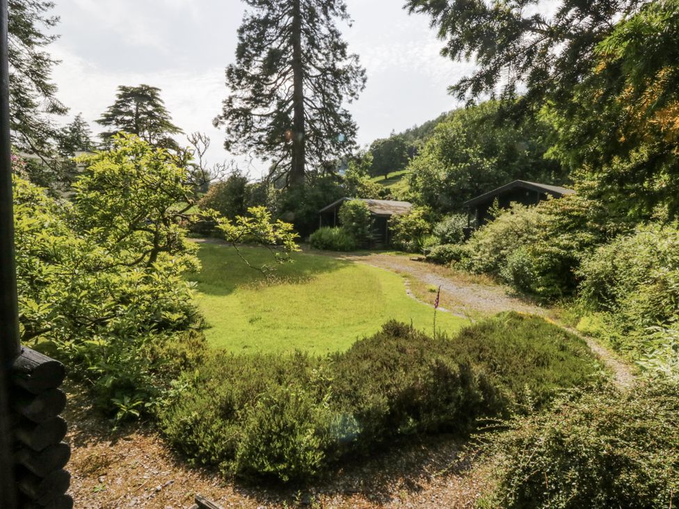 A garden area with trees and a path at Grasmere in Spark Bridge near Greenodd