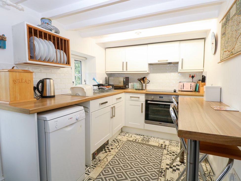 A kitchen with appliances and utensils at Broom Cottage in East Rudham near Fakenham