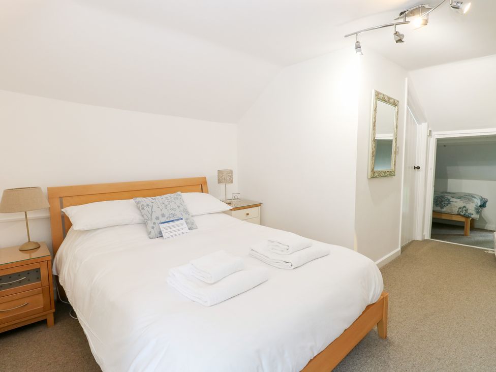 A bedroom with a bed and nightstand at Broom Cottage East Rudham near Fakenham