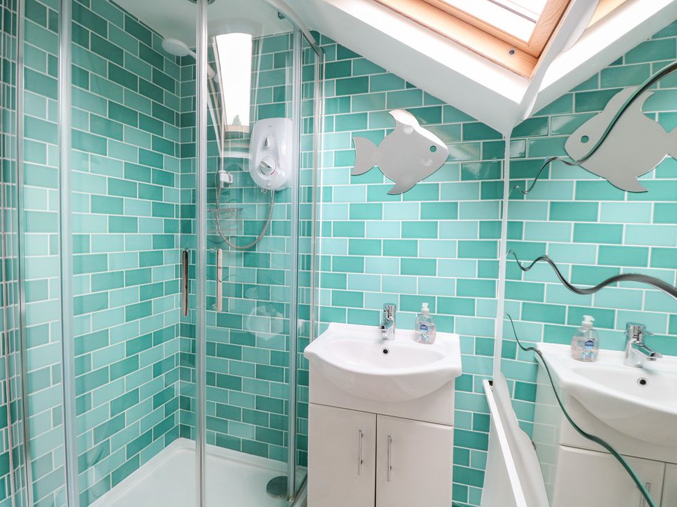A bathroom with a shower and sink at Broom Cottage East Rudham near Fakenham