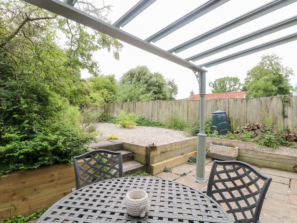 A garden with a table and chairs at Broom Cottage East Rudham near Fakenham