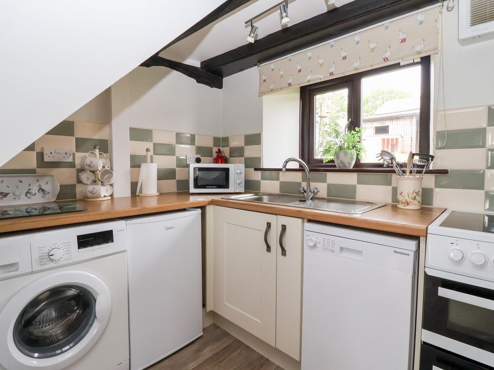 A kitchen with appliances and a sink at Wethercote Cottage in Old Byland near Helmsley