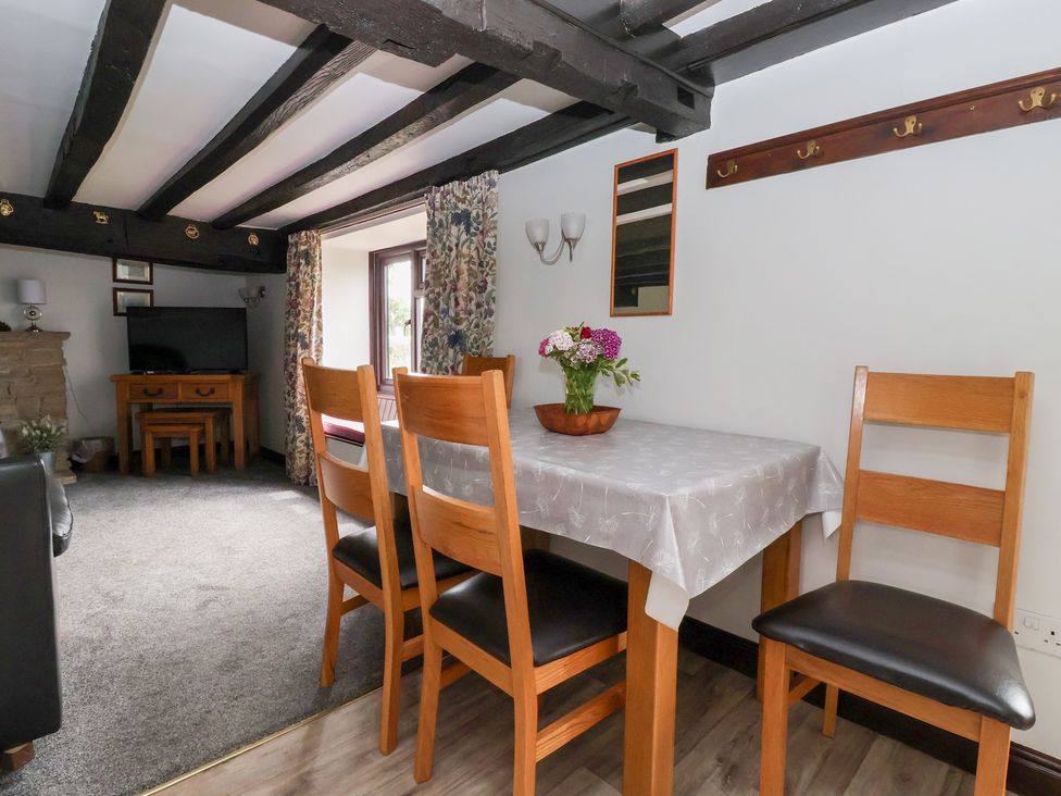 A dining room with a table and chairs at Wethercote Cottage in Old Byland near Helmsley