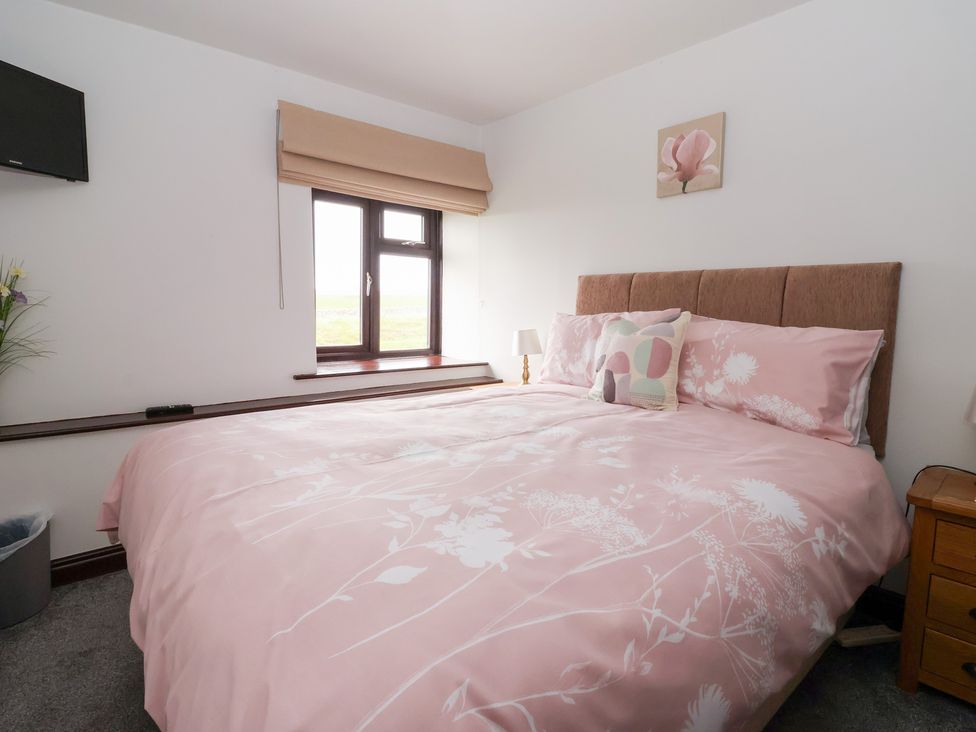 A bedroom with a bed and bedside table at Wethercote Cottage Old Byland near Helmsley