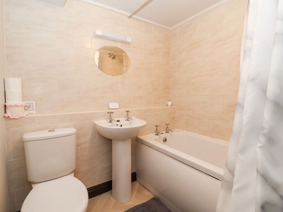 A bathroom with a toilet, sink and bathtub at Wethercote Cottage Old Byland near Helmsley