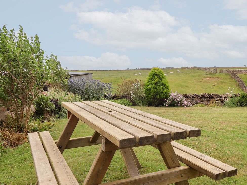 A picnic table in a garden at Wethercote Cottage Old Byland near Helmsley