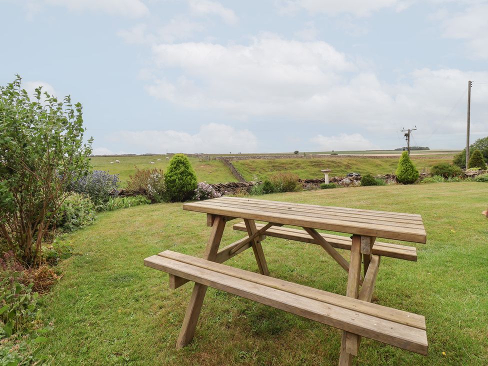 A picnic table in a garden at Wethercote Cottage in Old Byland near Helmsley