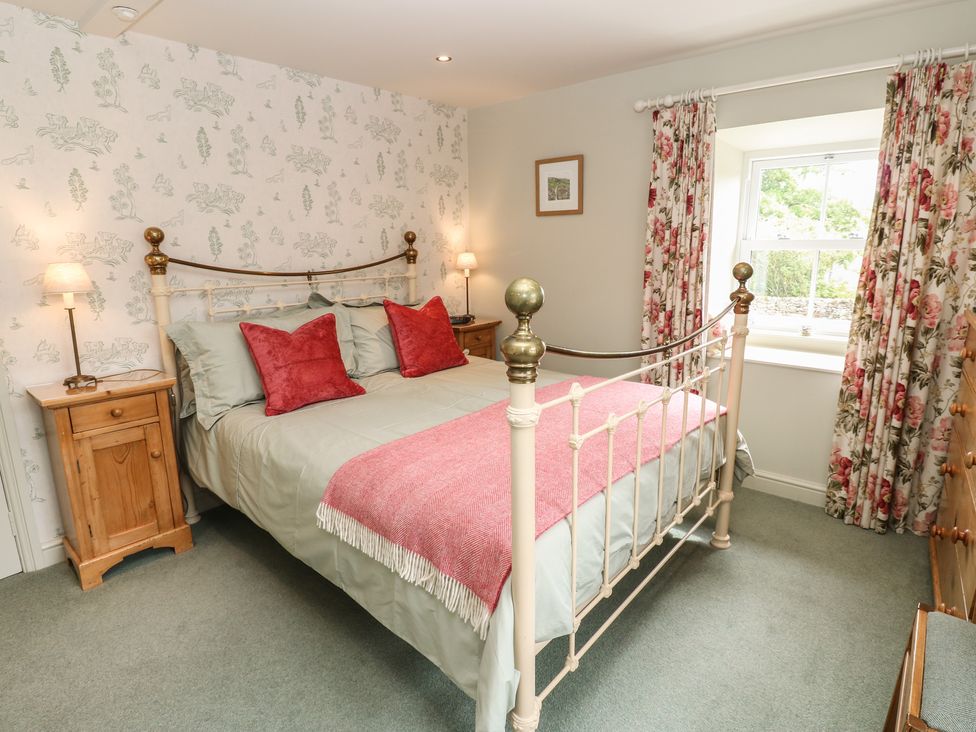 A bedroom with a double bed and bedside tables at Bill's Place in Bainbridge near Hawes
