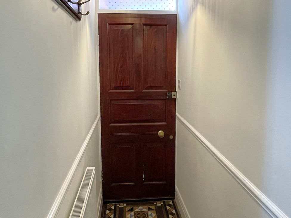 A hallway with a door and coat hook at Sterling House in Robin Hood's Bay