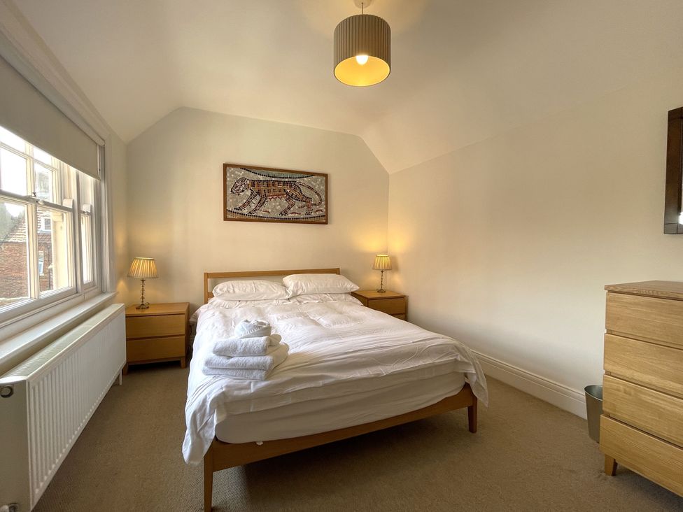 A bedroom with a bed and bedside lamps at Sterling House in Robin Hood's Bay