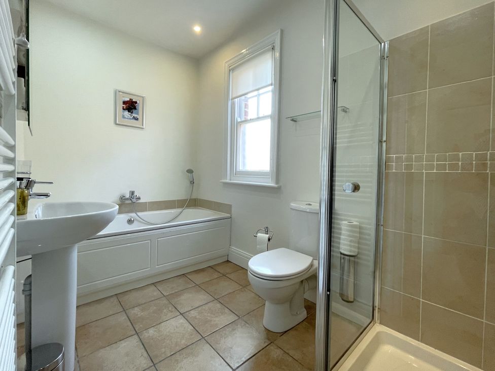 A bathroom with a shower and bathtub at Sterling House in Robin Hood's Bay