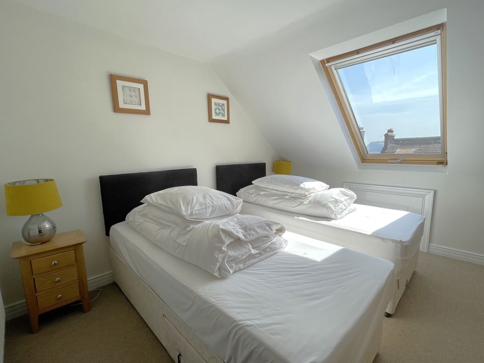 A bedroom with two beds and a window at Sterling House in Robin Hood's Bay