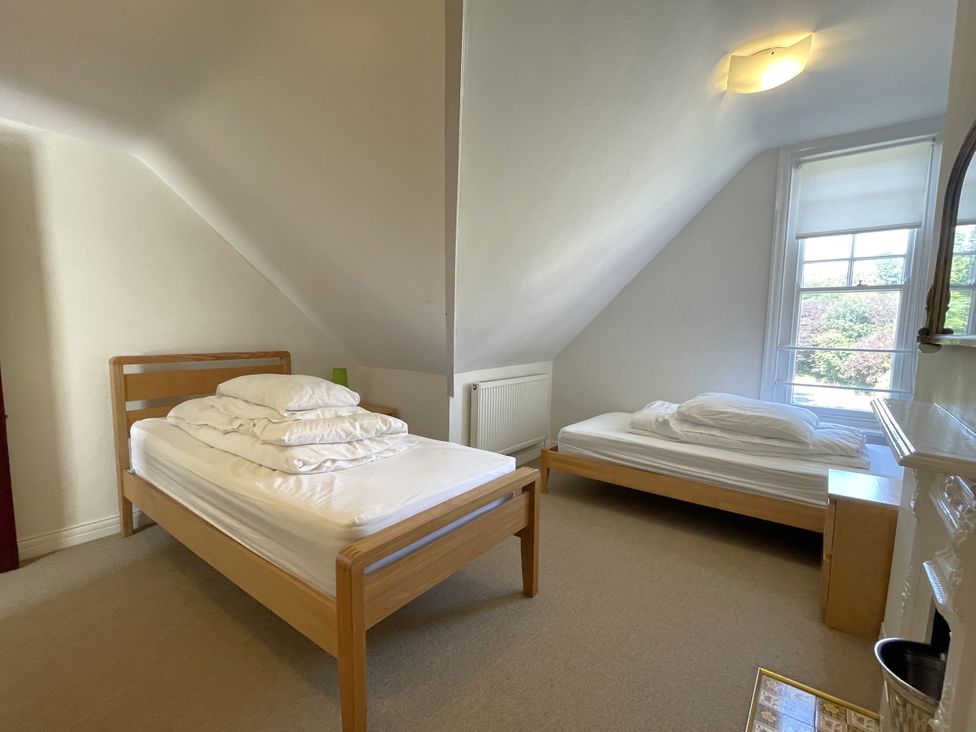 A bedroom with two beds and a window at Sterling House in Robin Hood's Bay