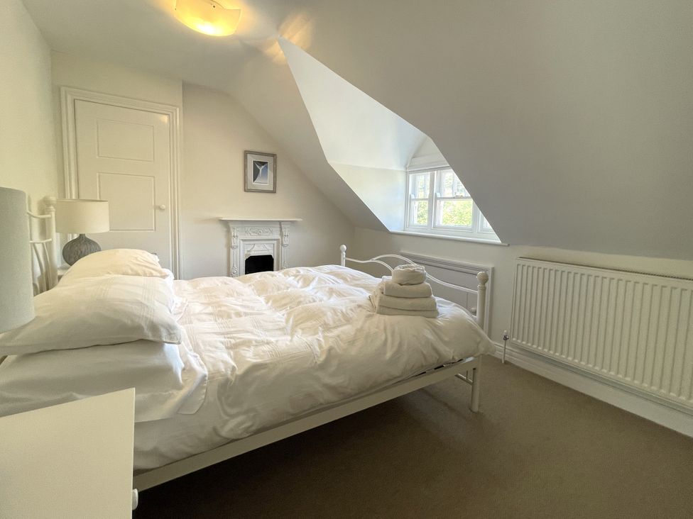 A bedroom with a bed and towels folded on it at Sterling House in Robin Hood's Bay