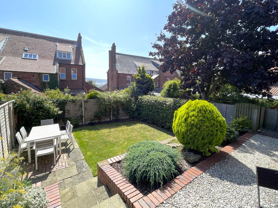 A garden with a table and chairs at Sterling House in Robin Hood's Bay