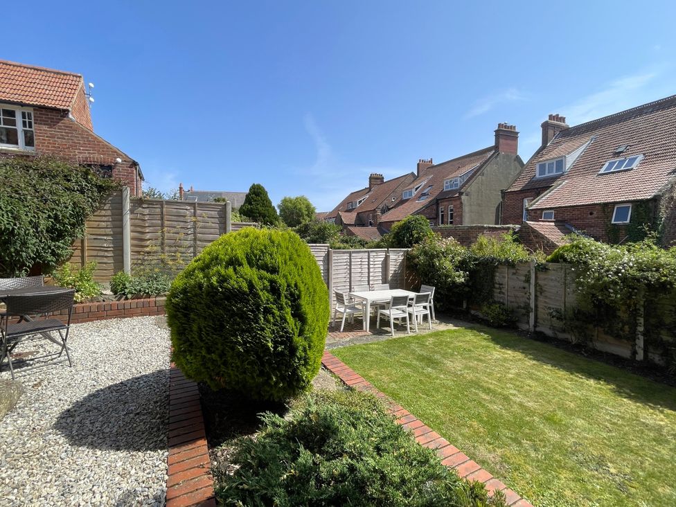 A garden with table and chairs at Sterling House in Robin Hood's Bay