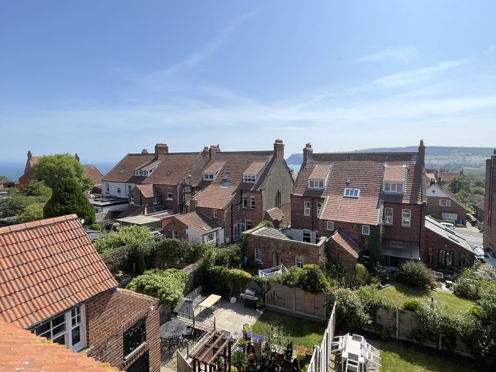 A view of houses and gardens overlooking the sea at Sterling House in Robin Hood's Bay