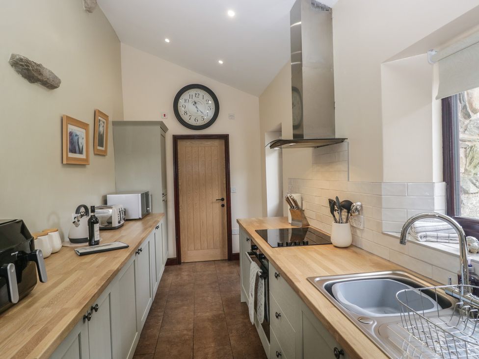 A kitchen with appliances and cabinetry at Woodside Barn Pennington near Ulverston