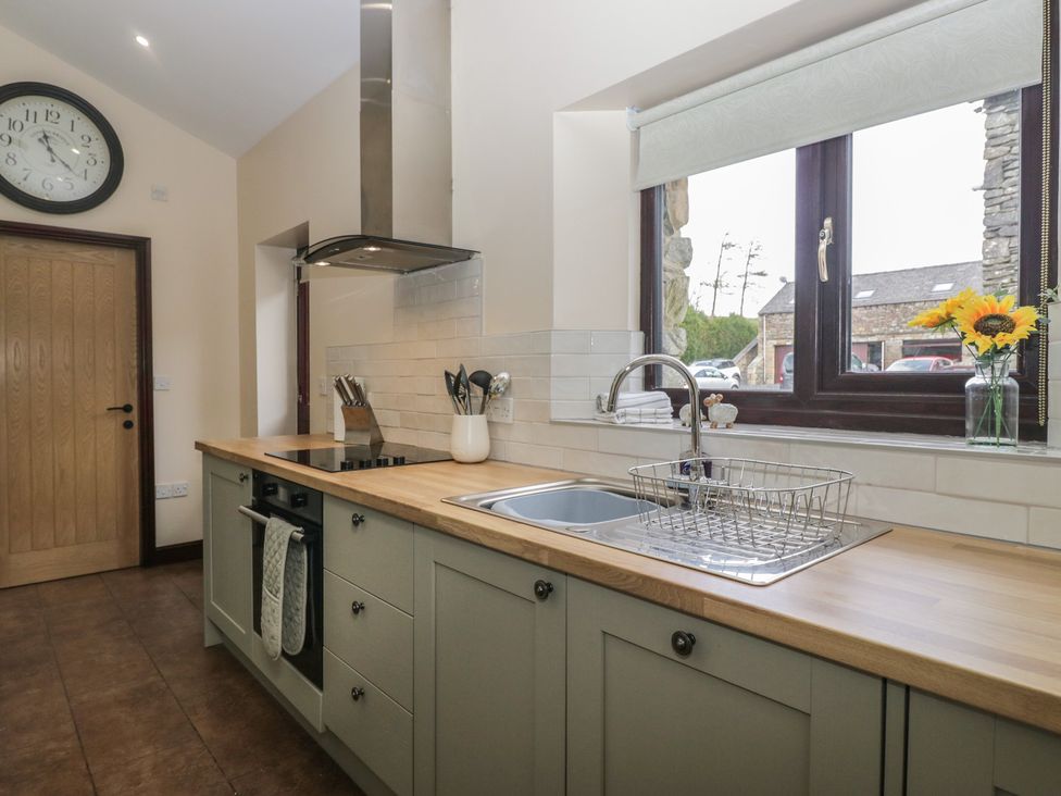 A kitchen with sink and cabinets at Woodside Barn Pennington near Ulverston