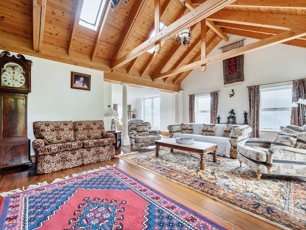 A living room with a sofa and a coffee table at Chapel Green in Polgooth