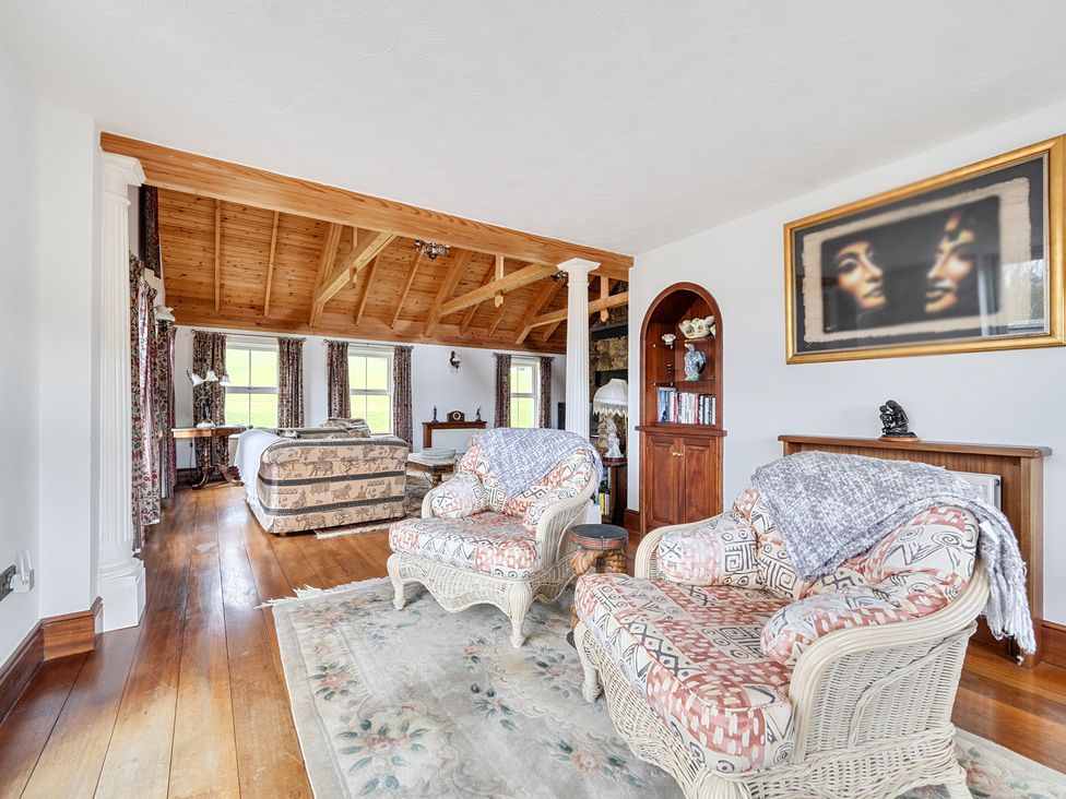 A living room with a sofa and armchairs at Chapel Green in Polgooth