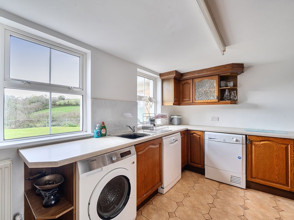 A kitchen with a sink and appliances at Chapel Green in Polgooth