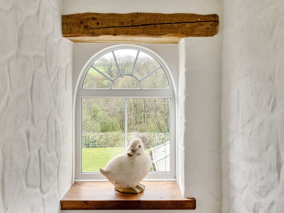 A window with a decorative object on the sill at Chapel Green in Polgooth